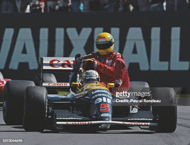 Nigel Mansell driving the Canon Williams Renault Williams FW14 Renault V10 gives Ayrton Senna a ride back to the pits after he had run out of fuel...