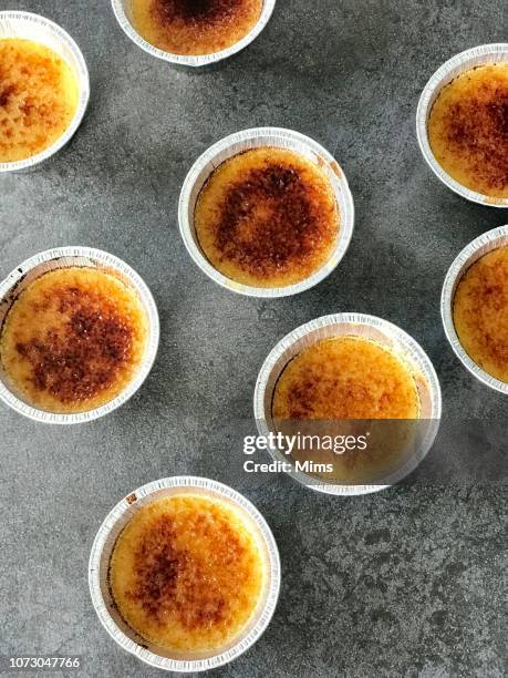 silver foil ramekins with creme brulee - creme brulee stock pictures, royalty-free photos & images