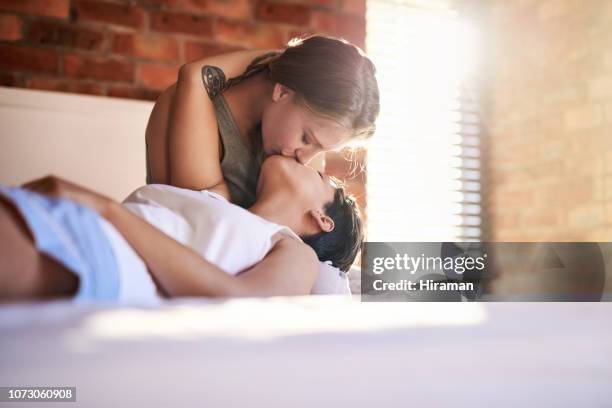shhh, just kiss me! - lesbian bed stock pictures, royalty-free photos & images
