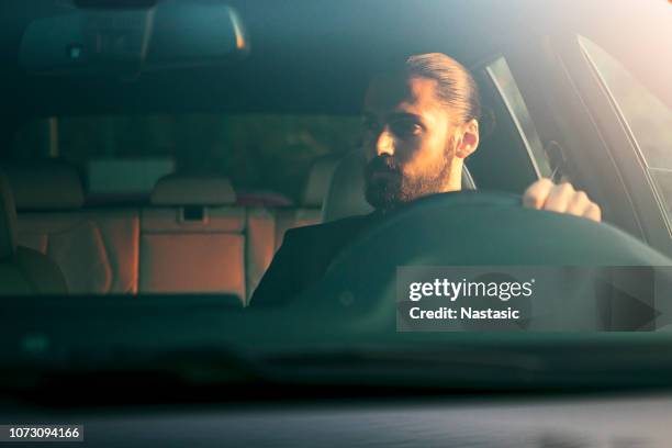 young man in car - luxury cars stock pictures, royalty-free photos & images