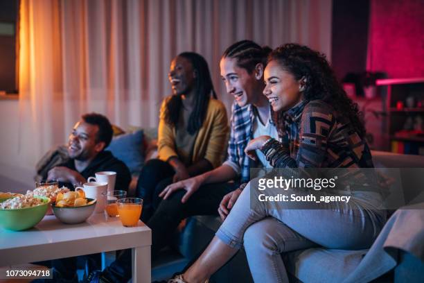 friends watching a movie - watching tv couple night stock pictures, royalty-free photos & images