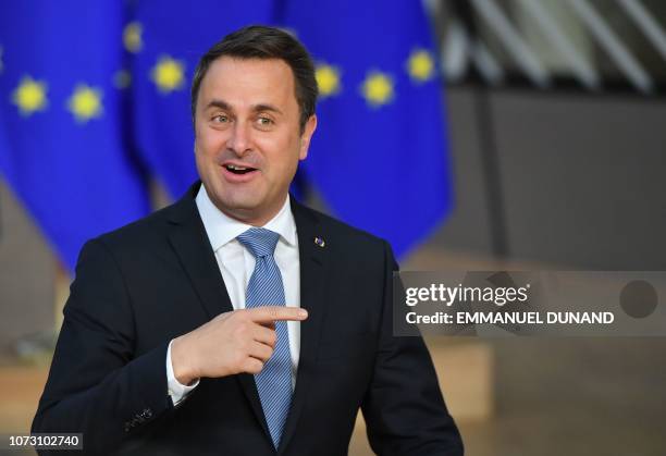 Luxembourg's Prime Minister Xavier Bettel gestures as he arrives on December 14, 2018 in Brussels during the second day of a European Summit aimed at...