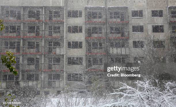 An unfinished residential apartment complex, originally intended for power plant workers, stands during a blizzard outside of Belene, Bulgaria, on...