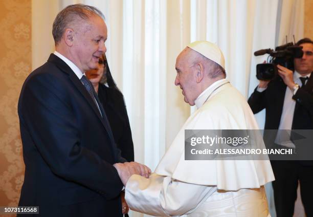 Pope Francis greets Slovakia's President Andrej Kiska upon his arrival for a private audience at the Vatican on December 14, 2018.