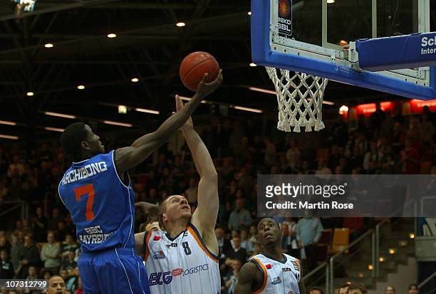 Koko Archibong of Bayreuth shoots against Andrew Drevo of Bremerhaven during the Basketball Bundesliga match between Eisbaeren Bremerhaven and BBC...