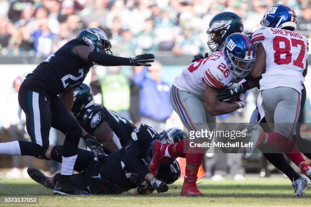 Saquon Barkley of the New York Giants runs the ball against Corey Graham, Nate Gerry, and Malcolm Jenkins of the Philadelphia Eagles at Lincoln...