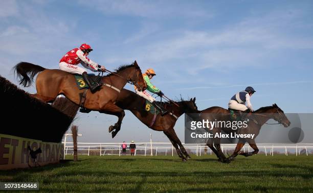 Nobel Leader ridden by Ben Poste clears the last fence ahead of Loch Garman Aris ridden by Tom Scudamore and Knocknamona ridden by Alain Cawley on...