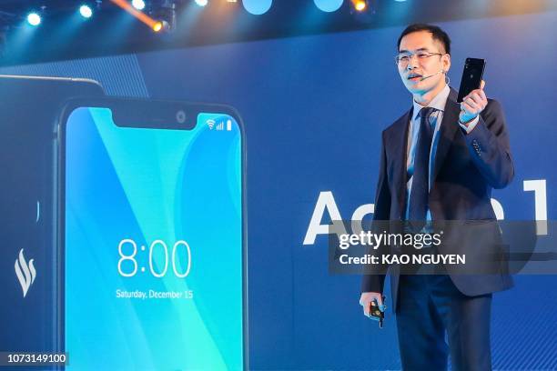 Vingroup's mobile phone subsidiary VinSmart's Chief Executive Officer Tran Minh Trung presents the "Active 1+" smartphone during a launch in Ho Chi...