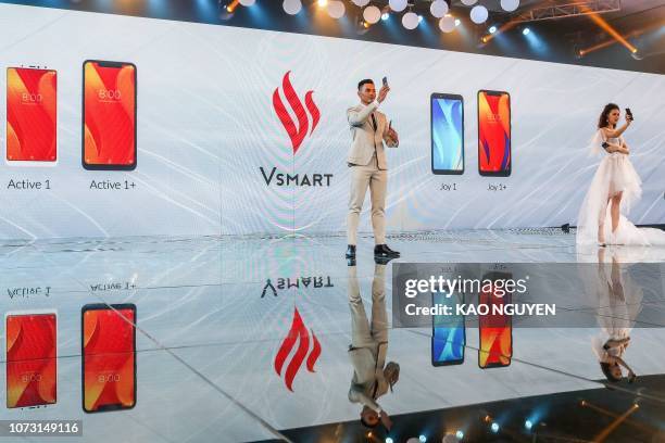 Vietnamese models present VinSmart's new smartphones, a subsidiary of Vingroup during a launch in Ho Chi Minh city on December 14, 2018. - Vietnam's...