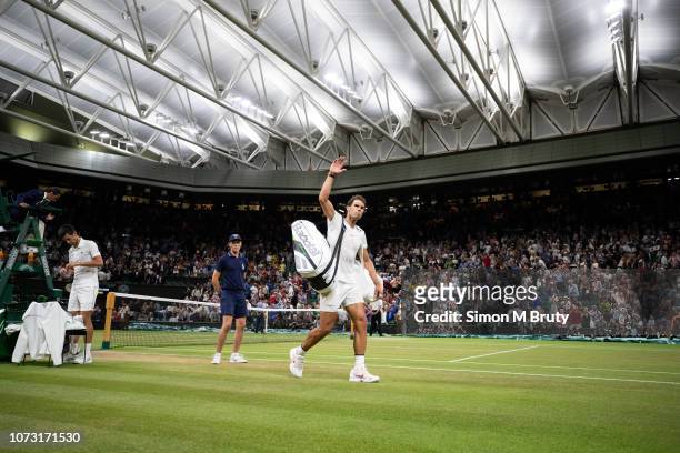 Rafael Nadal from Spain waves to the crowd after the game against Novak Djokovic from Serbia is delayed due to the curfew at Wimbledon of 11PM. The...