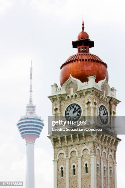 the tower of sultan abdul samad building with the menara kuala lumpur (kl tower)kuala lumpur, malaysia - dataran merdeka stock pictures, royalty-free photos & images