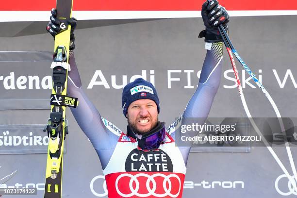 Norway's Aksel Lund Svindal celebrates on the podium after winning the FIS Alpine World Cup Men Super G on December 14, 2018 in Val Gardena -...