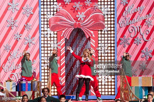 In this handout photo provided by Disney, Grammy Award-winning singer Mariah Carey waves to the crowd in front of an oversized Christmas card while...