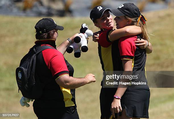 Charlotte Wilson of Waikato is congratulated by teammate Hannah Seifert at the 18th hole after winning her semi-final match on the final day of the...