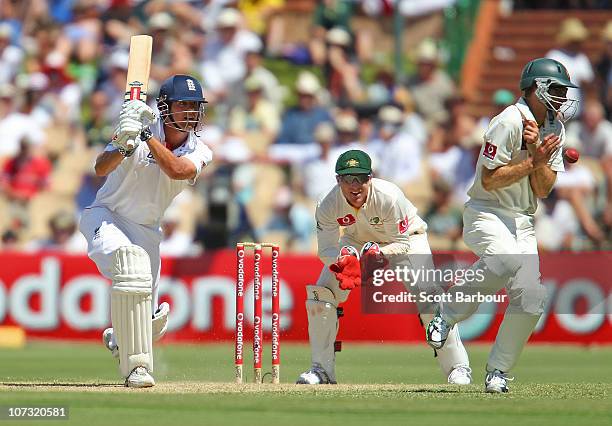 Alastair Cook of England hits the ball into the back of Simon Katich of Australia as wicketkeeper Brad Haddin of Australia looks on during day two of...