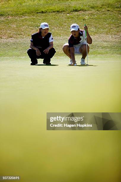 Lydia Ko of North Harbour lines up a putt with her caddy during the final on the final day of the Women's Interprovincial Golf Championship at...