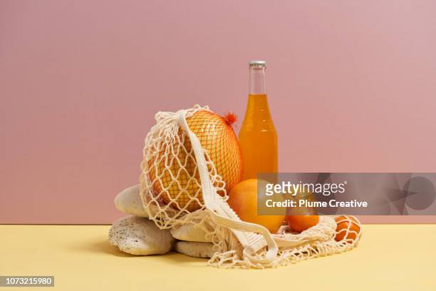 Mesh bag with fruit and soda