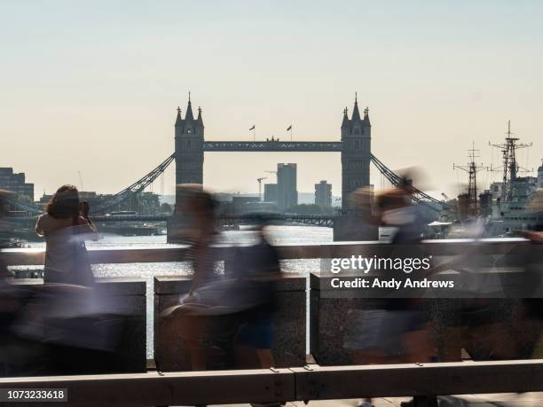 tourist taking a photo on a busy street - london bridge stock pictures, royalty-free photos & images