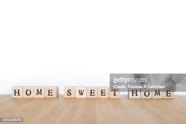 phrase made of wooden dice - home sweet home stockfoto's en -beelden