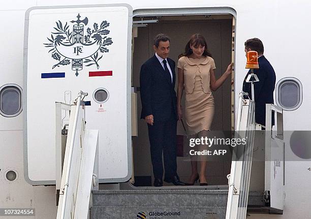 French president Nicolas Sarkozy and his wife Carla Bruni-Sarkozy disembark from the new French presidential Airbus A330 airplane as they arrive in...