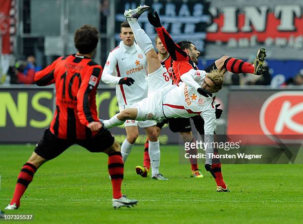 Georgios Tzavellas of Frankfurt battles for the ball with Marcel Risse of Mainz during the Bundesliga match between Eintracht Frankfurt and FSV Mainz...
