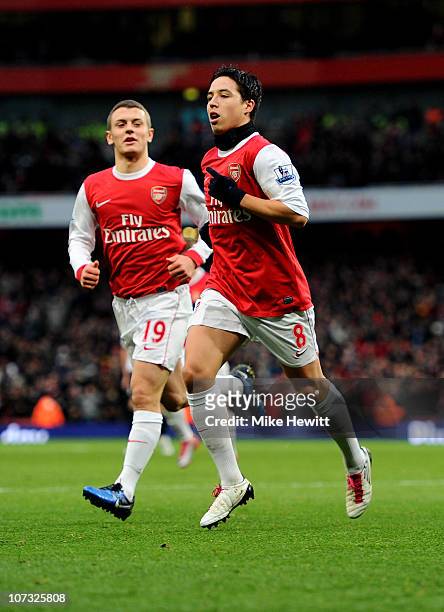 Samir Nasri of Arsenal celebrates with teammate Jack Wilshere after scoring the opening goal during the Barclays Premier League match between Arsenal...