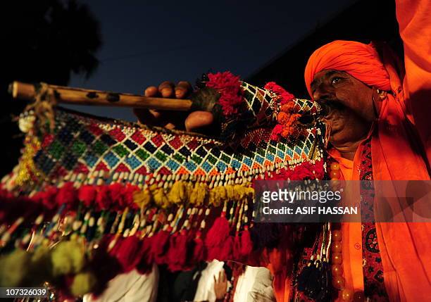 Pakistani folk dancer performs during Sindh Culural Day festival in Karachi on December 4, 2010. The day observed to highlight the culture of the...