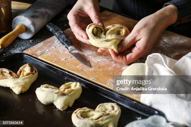 woman preparing a cinnamon buns - coffee cake stock pictures, royalty-free photos & images
