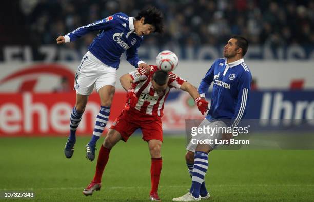 Atsuto Uchida of Schalke jumps for the ball next to Franck Ribery and team mate Edu during the Bundesliga match between FC Schalke 04 and FC Bayern...