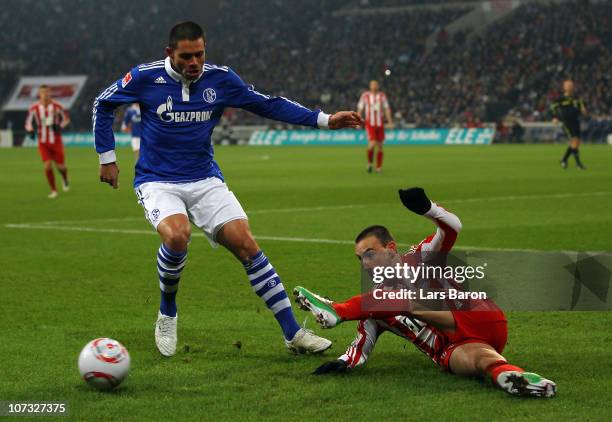 Edu of Schalke challenges Diego Contento of Muenchen during the Bundesliga match between FC Schalke 04 and FC Bayern Muenchen at Veltins Arena on...