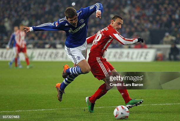 Klaas Jan Huntelaar of Schalke is challenged by Diego Contento of Muenchen during the Bundesliga match between FC Schalke 04 and FC Bayern Muenchen...