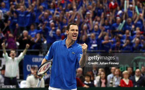 Michael Llodra celebrates winning the fourth set with Arnaud Clement of France in their doubles match against Nenad Zimonjic and Viktor Troicki of...