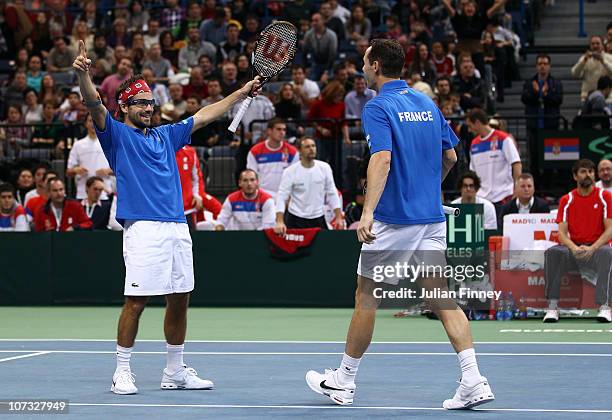 Michael Llodra and Arnaud Clement of France celebrate at match point as they beat Nenad Zimonjic and Viktor Troicki of Serbia in the doubles during...