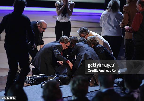 Samuel Koch receives first aid after he falls down the floor after he jumped over a car during the 192th 'Wetten, dass ...?' show at the exhibition...