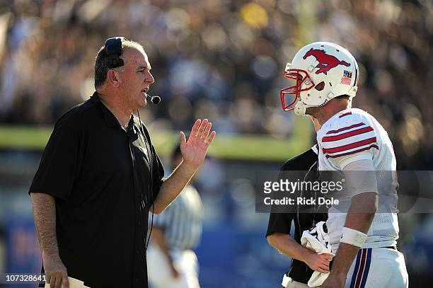 Head coach June Jones of the SMU Mustangs talks with quarterback Kyle Padron at Bright House Networks Stadium on December 4, 2010 in Orlando, Florida.
