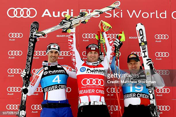 Adrien Theaux of France, Georg Streitberger of Austria and Didier Cuche of Switzerland pose for photographers on the medals podium after winning the...