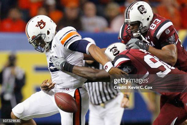 Devin Taylor and Cliff Matthews of the South Carolina Gamecocks force a fumble by quarterback Cam Newton of the Auburn Tigers during the 2010 SEC...