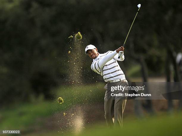 Tiger Woods hits his second shot on the 18th hole during round three of the Chevron World Challenge at Sherwood Country Club on December 4, 2010 in...