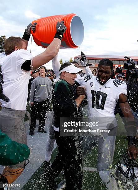 Head Coach Chip Kelly of the Oregon Ducks laughs with Drew Davis after having Gatorade dumped on him after the 37-20 victory over the Oregon State...