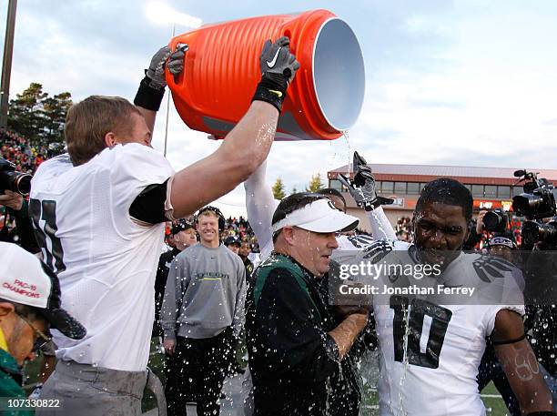 Head Coach Chip Kelly of the Oregon Ducks laughs with Drew Davis after having Gatorade dumped on him after the 37-20 victory over the Oregon State...