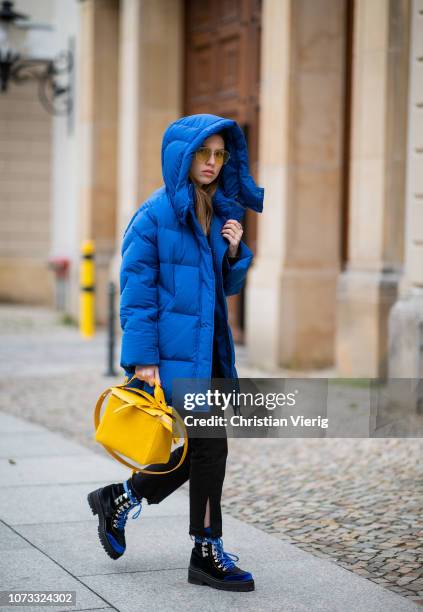 Swantje Soemmer is seen wearing royal blue down feather coat Woolrich, black jeans Boden, yellow bag Sophie Hulme, Edited boots, Marc Jacobs...