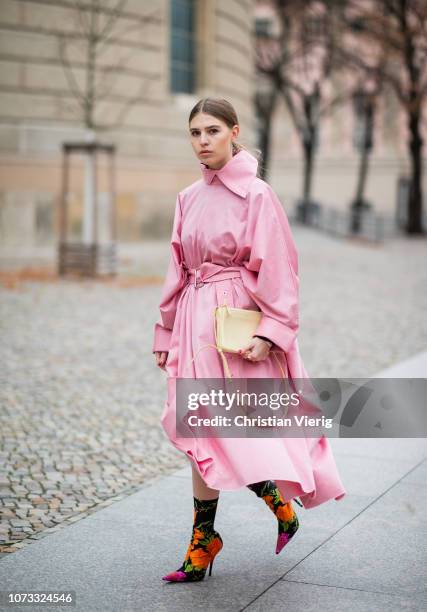 Swantje Soemmer is seen wearing pink belted coat Marques Almeida, Celine bag, Balenciaga sock boots with floral print on December 14, 2018 in Berlin,...