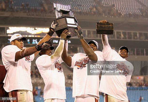 Teammates Andre Smith, Tyrod Taylor, John Graves and Davon Morgan of the Virginia Tech Hokies celebrate after winning the ACC Championship 44-33...