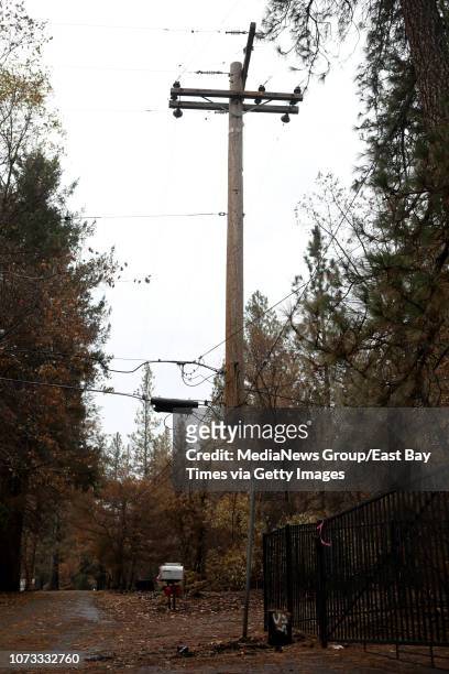 Power pole damaged by the Camp Fire poses a hazard according to fire officials in the town of Paradise, Calif., on Tuesday, Nov. 27, 2018. Numerous...