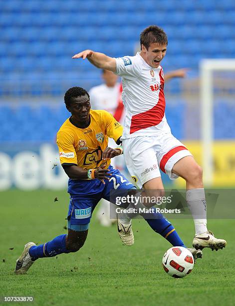 Michael Marrone of the Heart contests the ball with Adama Traore of the Gold Coast during the round 17 A-League match between Gold Coast United and...