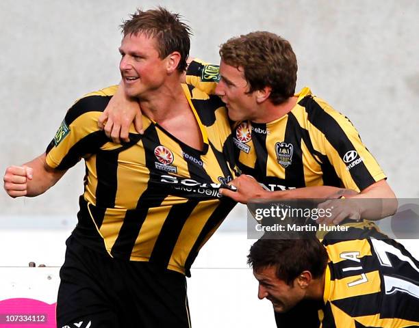 Ben Sigmund of the Phoenix is mobbed by team-mates Nick Ward and Vince Lia during the round 17 A-League match between the Wellington Phoenix and...