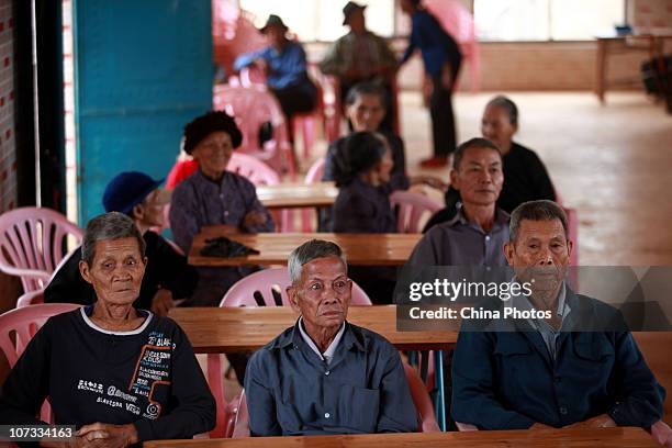 Senior citizens watch TV at the Huangzhu Village of Jinjiang Township on December 4, 2010 in Chengmai County of Hainan Province, China. Chengmai...