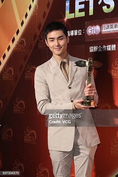 Taiwanese actor Ethan Ruan poses after winning the Best Film Music Award and the Best Art Directors Award during the 54th Asian Pacific Film Festival...