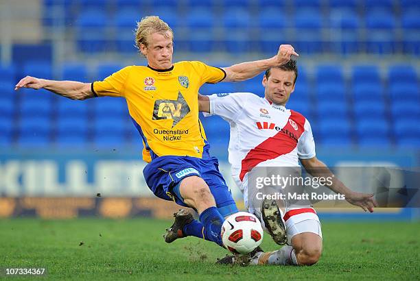 Sebastiaan Van Den Brink of the Gold Coast contetsts the ball with Nicholas Kalmar of the Heart during the round 17 A-League match between Gold Coast...