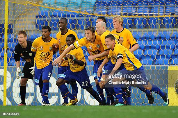 Players of the Gold Coast rush the ball out of the goals during the round 17 A-League match between Gold Coast United and the Melbourne Heart at...